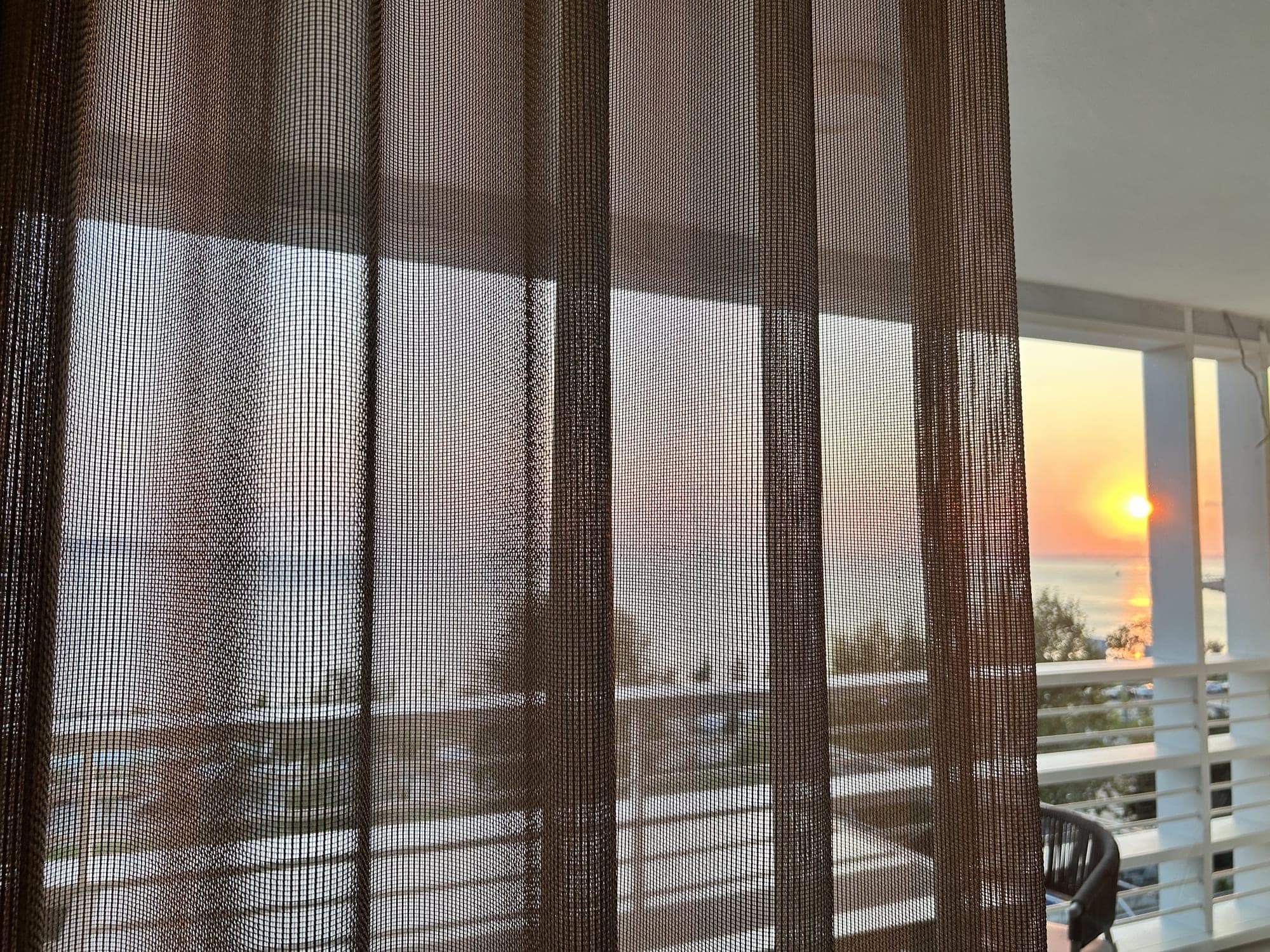 Tulle filtering the sunset over the sea