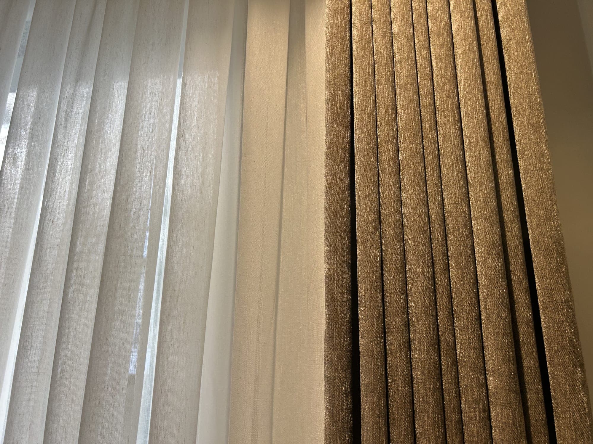 Close-up of the linen-textured sheer beside the textured drape